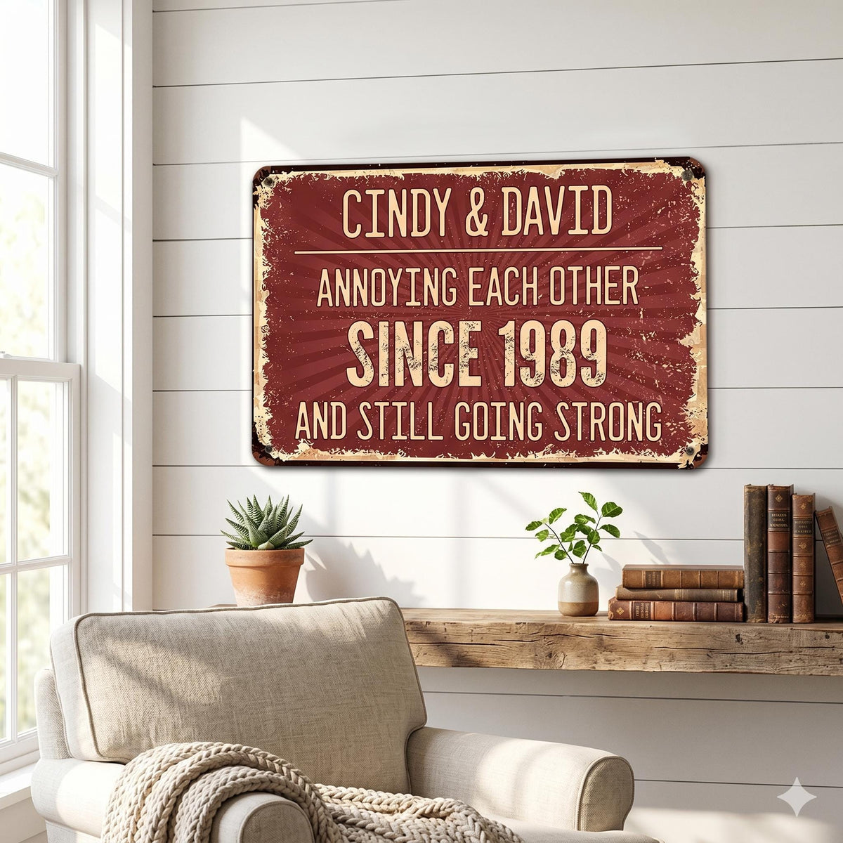 A rectangular metal sign with a distressed burgundy background and cream-colored text. The sign reads "Cindy & David Annoying Each Other Since 1989 And Still Going Strong."