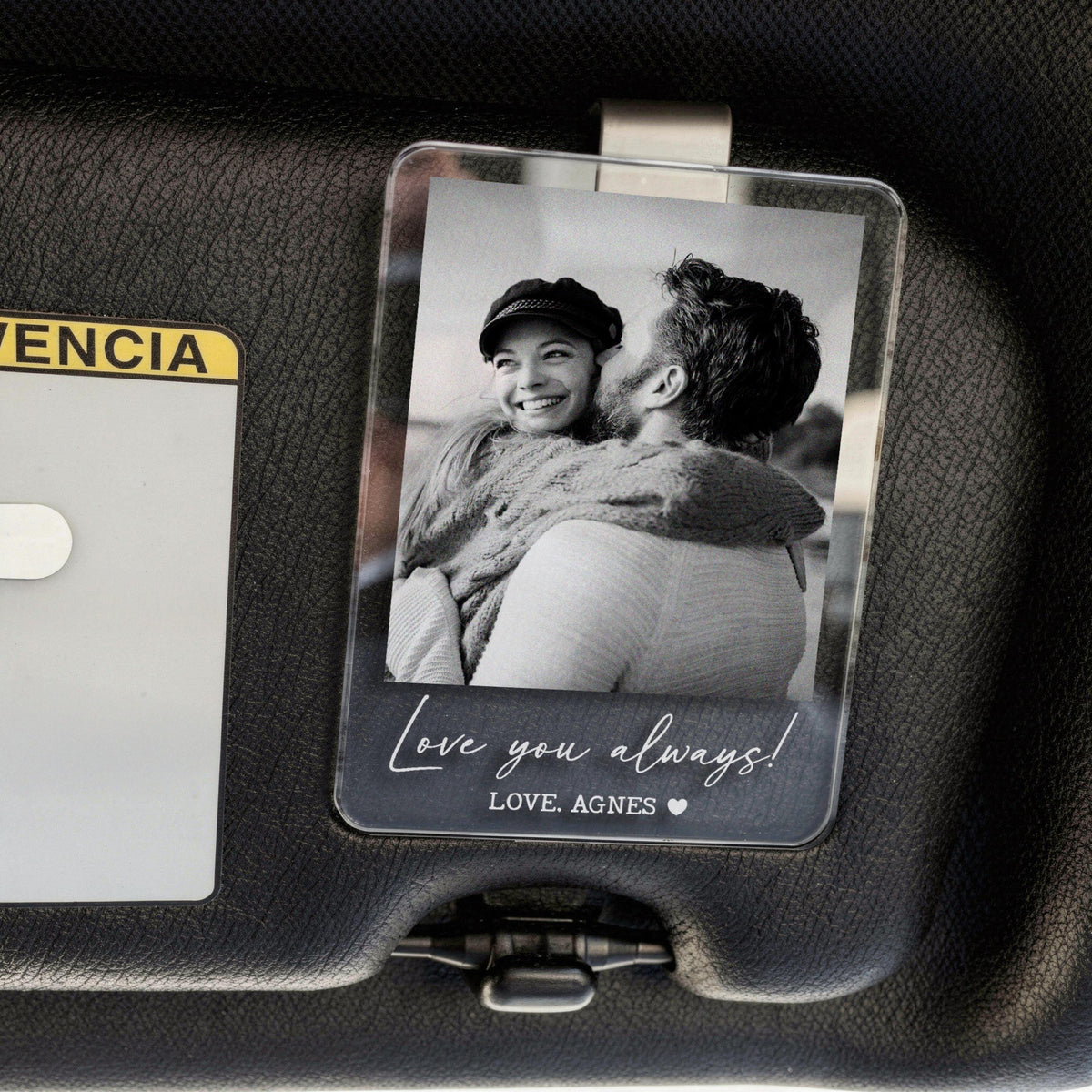 Clear acrylic visor clip featuring a black and white photo of a person embracing another person. The text "Love you always!" and "LOVE, AGNES" is printed on the bottom.