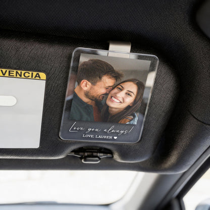 Clear acrylic car visor photo holder with a printed photo of a smiling couple. The holder has the text "Love you always!" and "LOVE, LAUREN" in a handwritten style font.