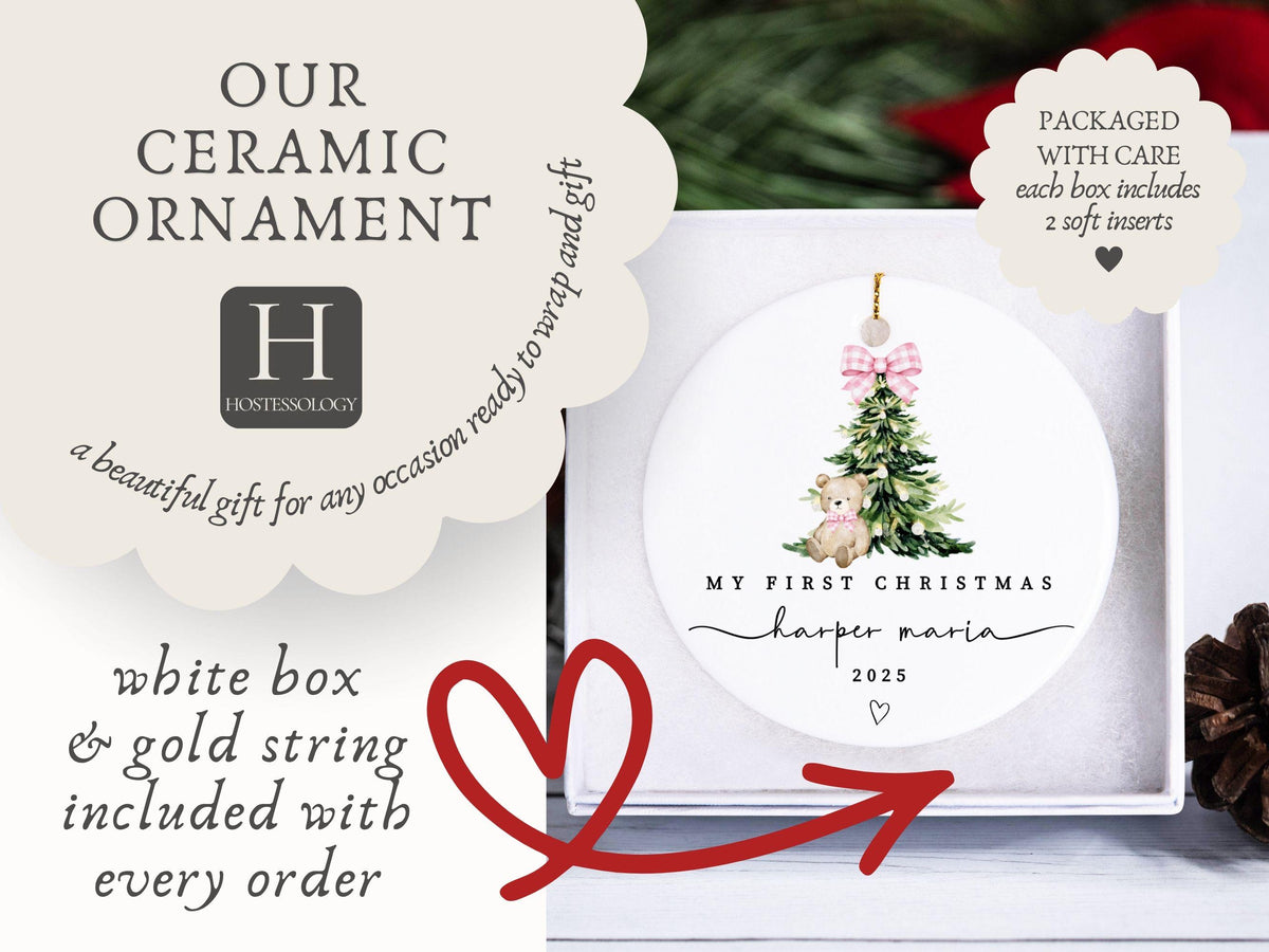 May include: A round white ceramic ornament featuring a watercolor illustration of a green Christmas tree with a pink plaid bow and a teddy bear. The text reads MY FIRST CHRISTMAS, harper maria, and 2025, with a small heart icon below.
