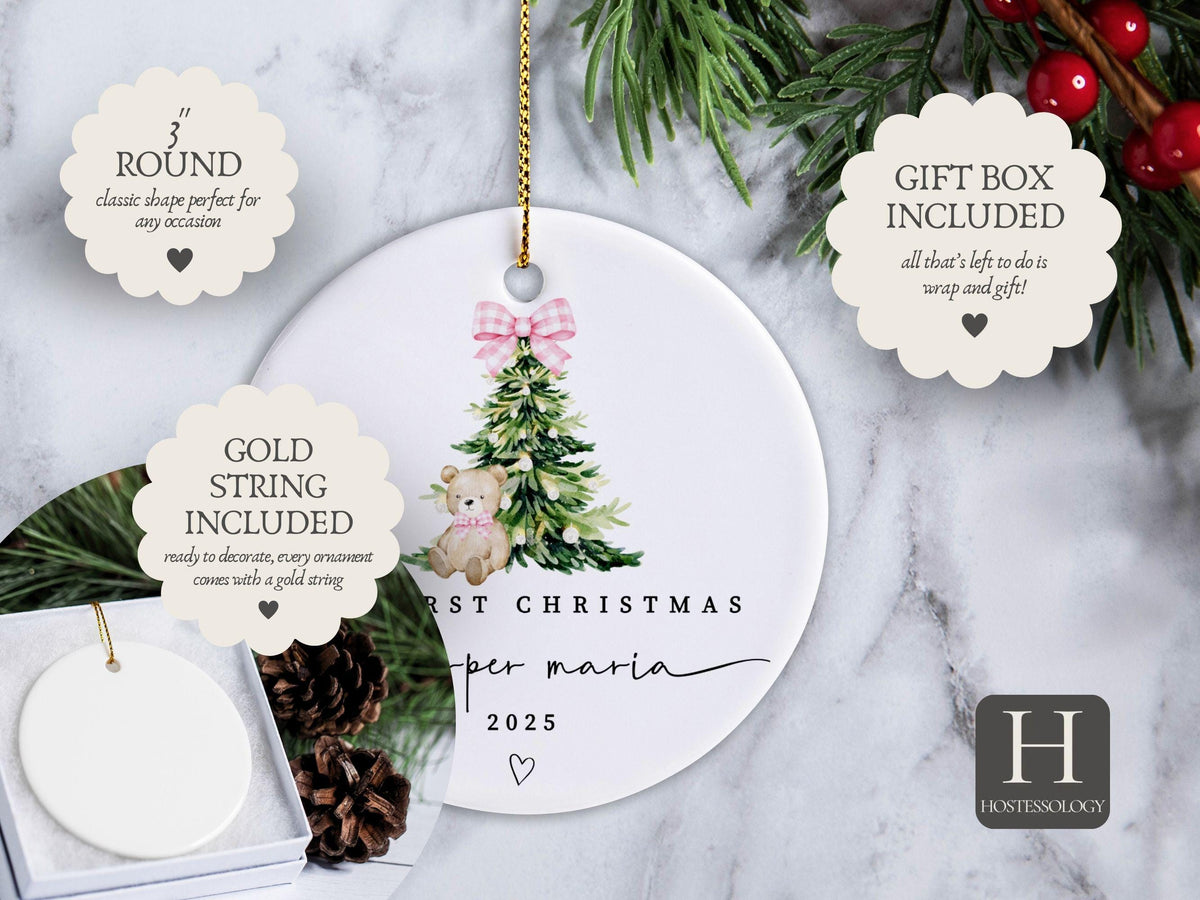 May include: A 3-inch round white ceramic ornament featuring a watercolor illustration of a green Christmas tree with a pink gingham bow and a teddy bear. The text reads FIRST CHRISTMAS, piper maria, and 2025, with a gold hanging string included.