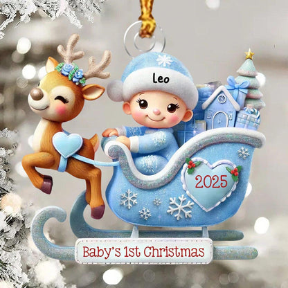May include: A decorative ornament featuring a brown reindeer with blue flowers on its antlers pulling a light blue sleigh. A baby wearing a blue hat with the name Leo sits in the sleigh, which is decorated with a heart labeled 2025 and the text Baby's 1st Christmas.