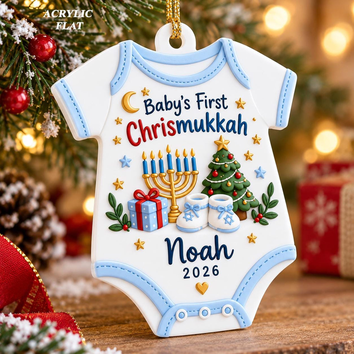 May include: A white acrylic flat ornament shaped like a baby onesie with light blue trim. It features the text Baby's First Chrismukkah, a gold menorah, a decorated Christmas tree, a blue gift box, baby booties, the name Noah, and the year 2026.
