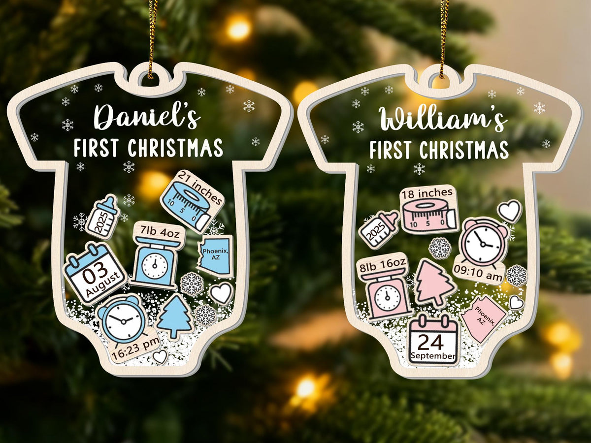 May include: Two baby onesie-shaped Christmas ornaments. One reads "Daniel's FIRST CHRISTMAS" with birth details: 21 inches, 7lb 4oz, August 3, 16:23 pm. The other reads "William's FIRST CHRISTMAS" with birth details: 18 inches, 8lb 16oz, September 24, 09:10 am.