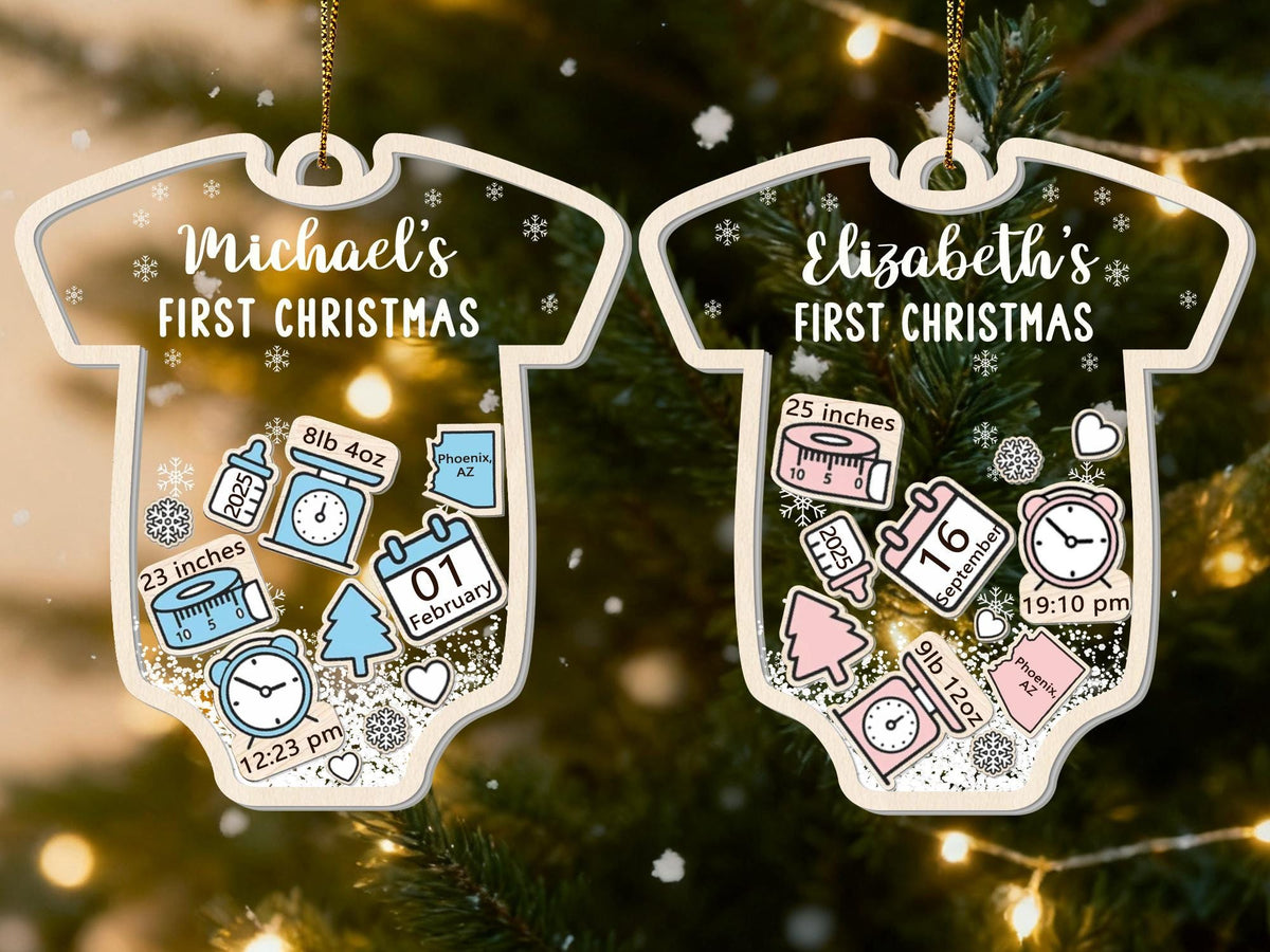May include: Two baby onesie-shaped Christmas ornaments. One reads "Michael's FIRST CHRISTMAS" and the other "Elizabeth's FIRST CHRISTMAS". Each ornament has details like weight, length, date, and time. One baby measured 23 inches and the other 25 inches.