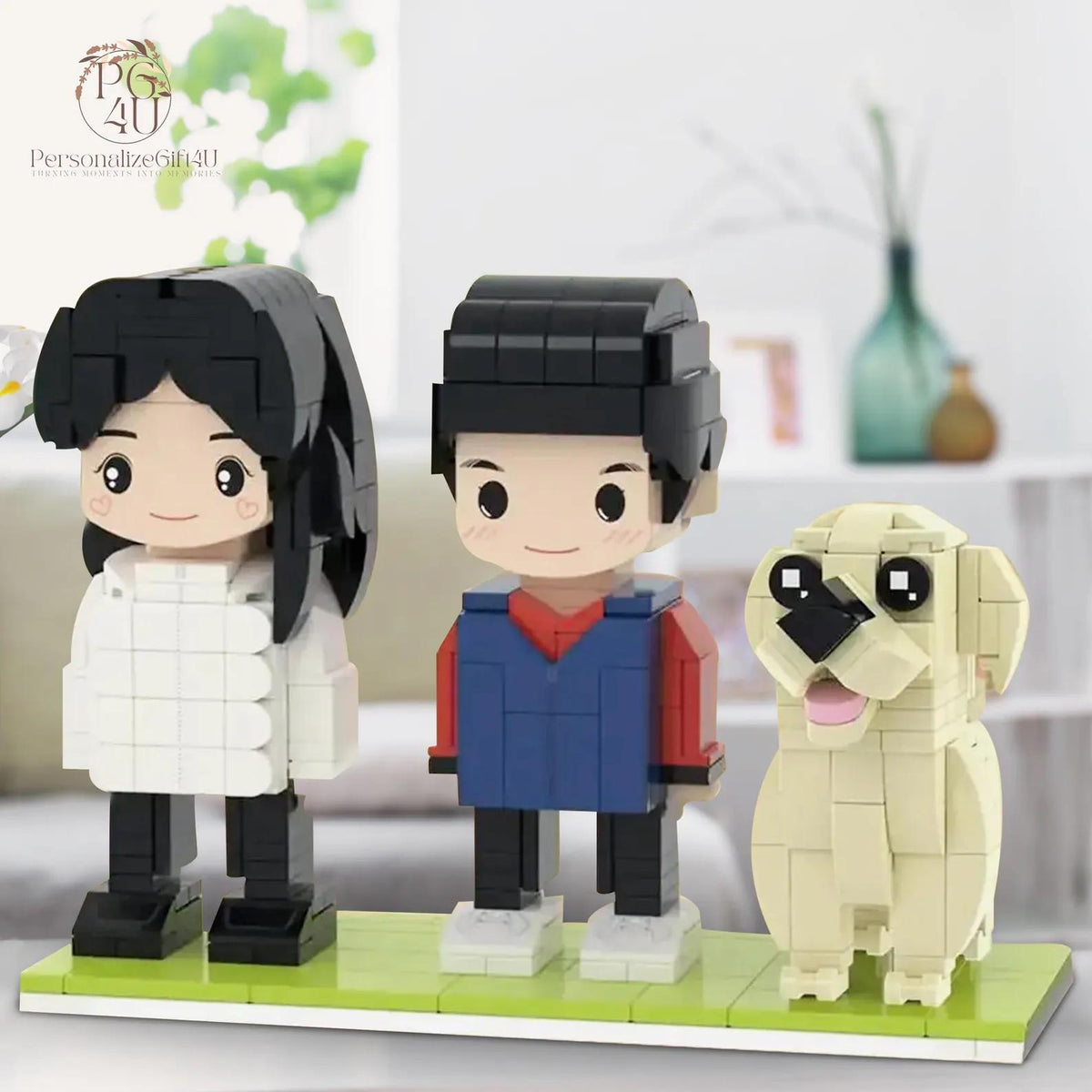 A set of three custom brick-built figures on a green base plate, featuring a person with black hair in a white jacket, a person with black hair in a blue and red top, and a cream-colored dog with a black nose and pink tongue.