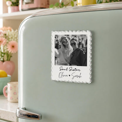 May include: A square refrigerator magnet with a scalloped edge featuring a black and white photograph of two people wearing sunglasses. Below the photo, the text reads Soul Sister followed by the names Olivia and Sarah with a small heart symbol.