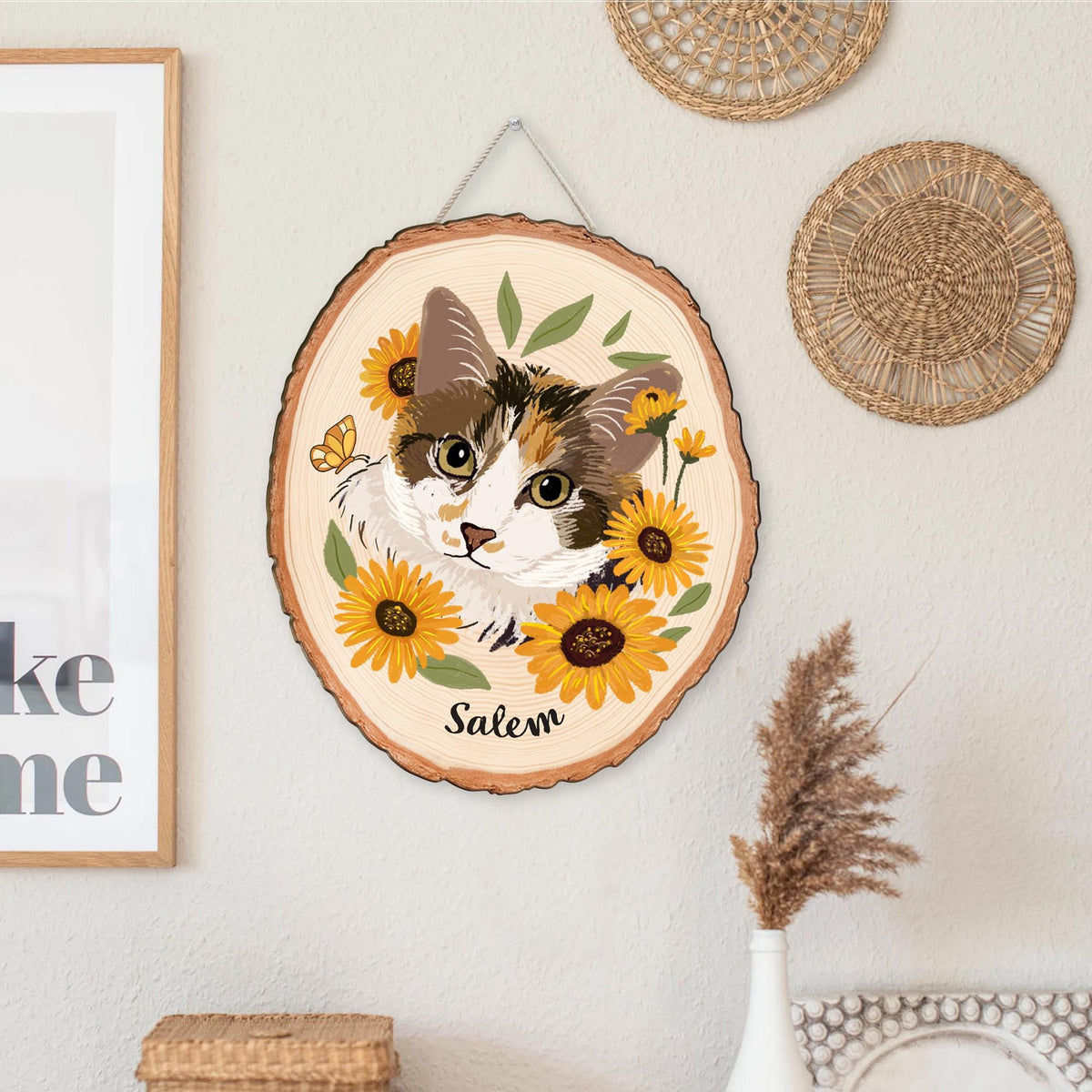 May include: A wooden slice wall hanging featuring a cat portrait surrounded by sunflowers and greenery. The cat has brown, white, and orange fur. The name "Salem" is written below the cat. A butterfly is also included in the design.