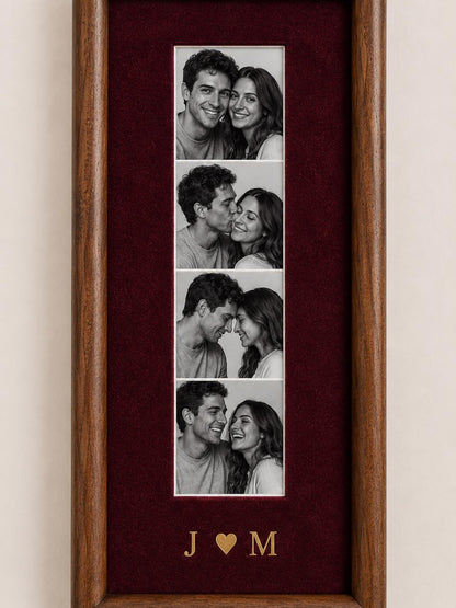 A vertical wooden picture frame with a deep red velvet mat containing four black and white photographs of a couple in various poses. Below the photos, the gold-colored letters J and M are separated by a small gold heart symbol.