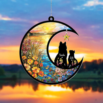 May include: A decorative crescent moon ornament featuring silhouettes of two dogs, Simba and Loki, with floral accents. The ornament is set against a stained-glass style sunset scene with a hanging star.