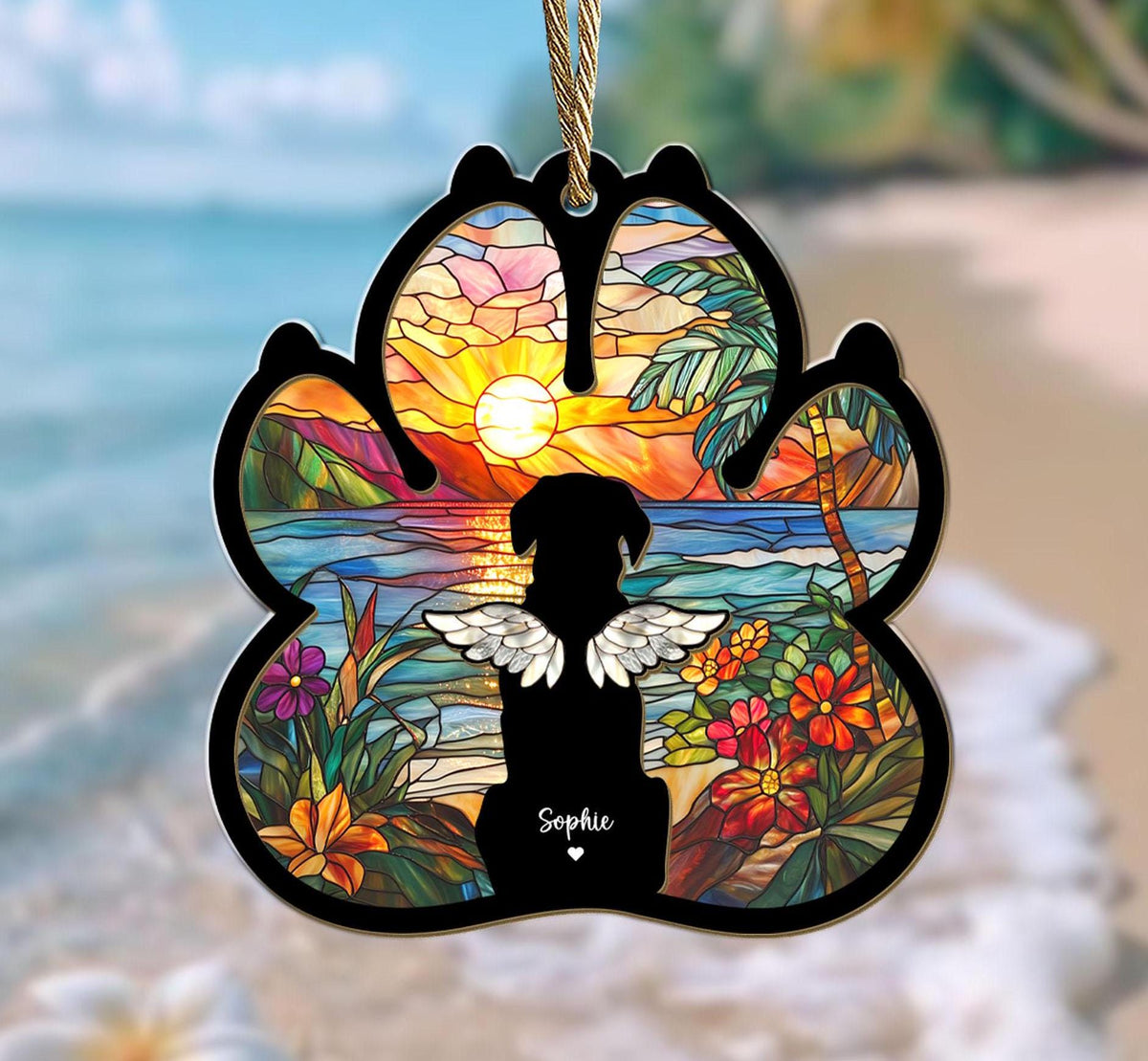 May include: A stained glass paw print ornament with a silhouette of a dog with wings, a tropical beach scene, and the name "Sophie" at the bottom.