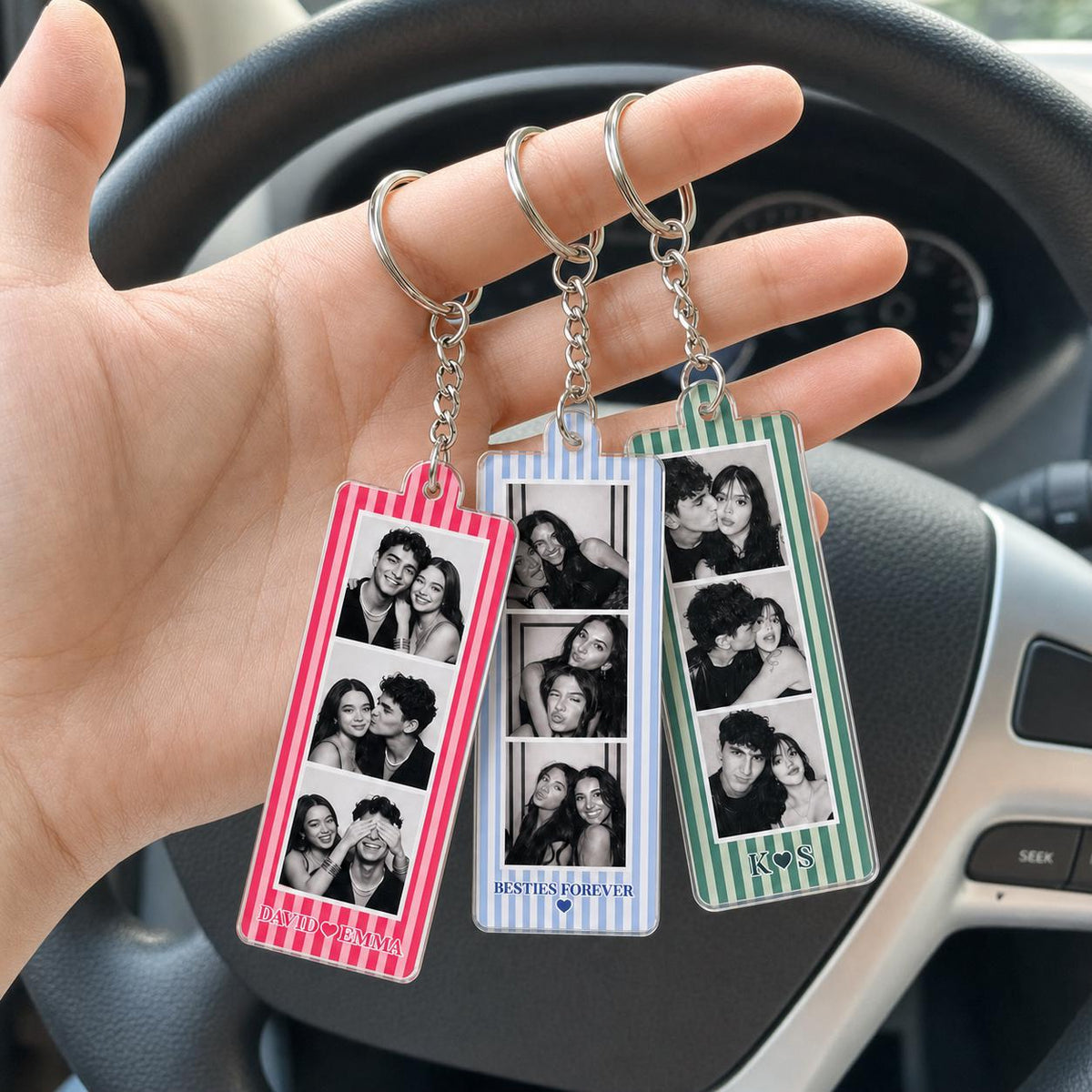 Three rectangular acrylic keychains featuring vertical striped borders in pink, light blue, and green. Each keychain displays three black and white photo booth-style images of couples. The pink keychain reads DAVID HEART EMMA, the blue reads BESTIES FOREVER, and the green reads K HEART S.