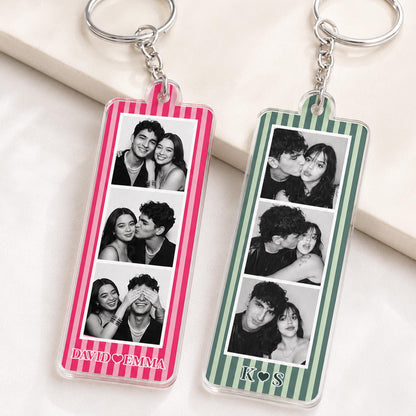 Two rectangular acrylic keychains with silver metal rings and chains. The left keychain has pink vertical stripes and the text DAVID EMMA. The right keychain has green vertical stripes and the text K S. Both feature three black and white photos.