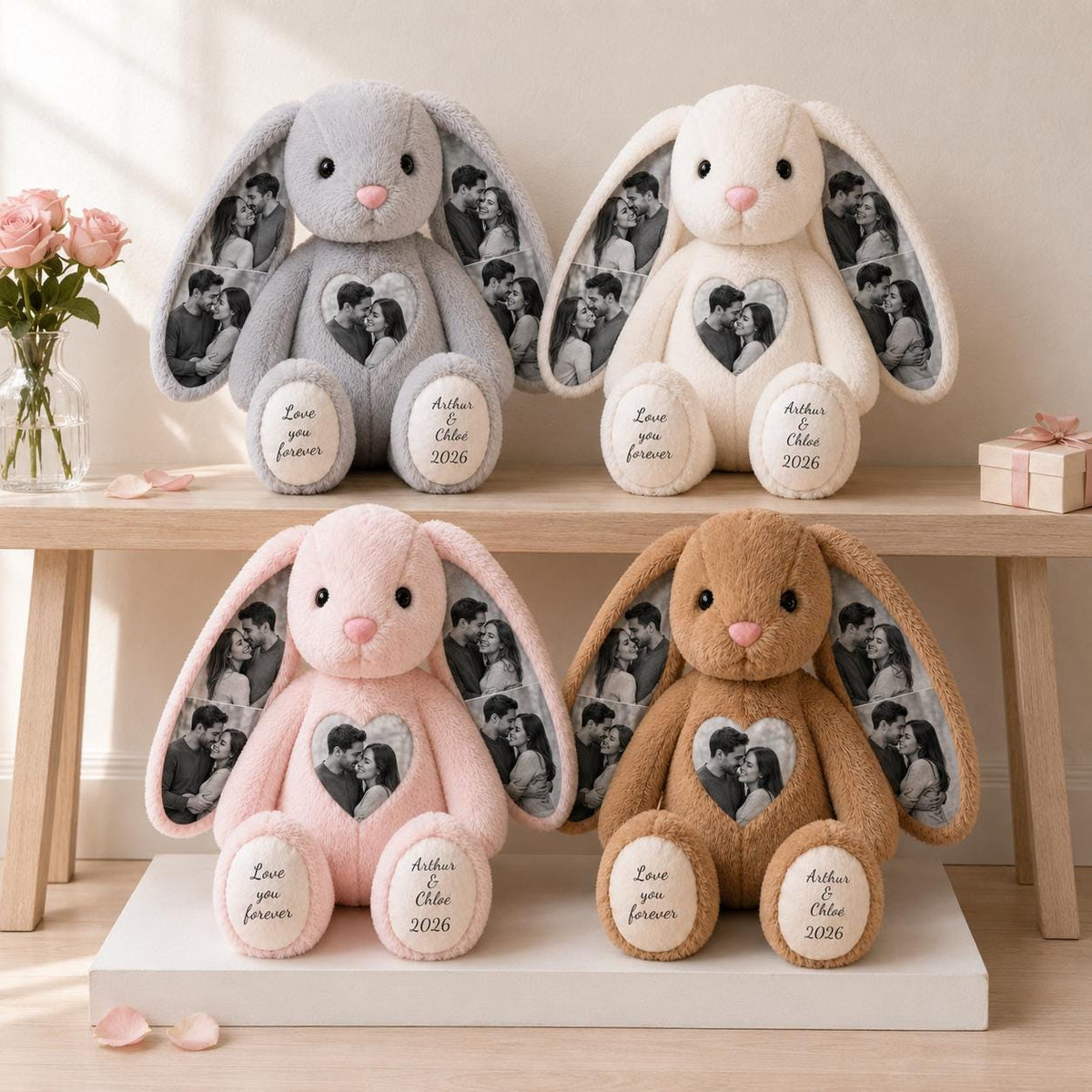 Four plush rabbit toys in gray, cream, pink, and brown. Each rabbit features a heart-shaped photo print on the chest, photo prints on the ears, and text on the feet reading Love you forever and Arthur & Chloe 2026.