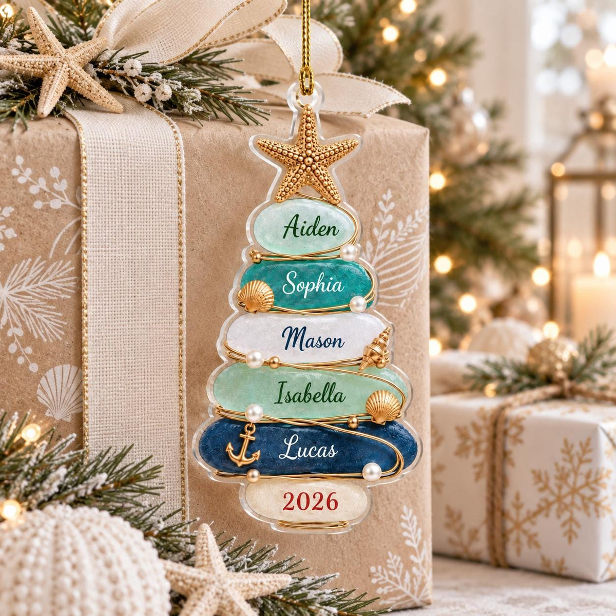 A clear, tree-shaped Christmas ornament featuring five horizontal layers in shades of light green, teal, white, and dark blue. Each layer is inscribed with the names Aiden, Sophia, Mason, Isabella, and Lucas, with 2026 at the base.