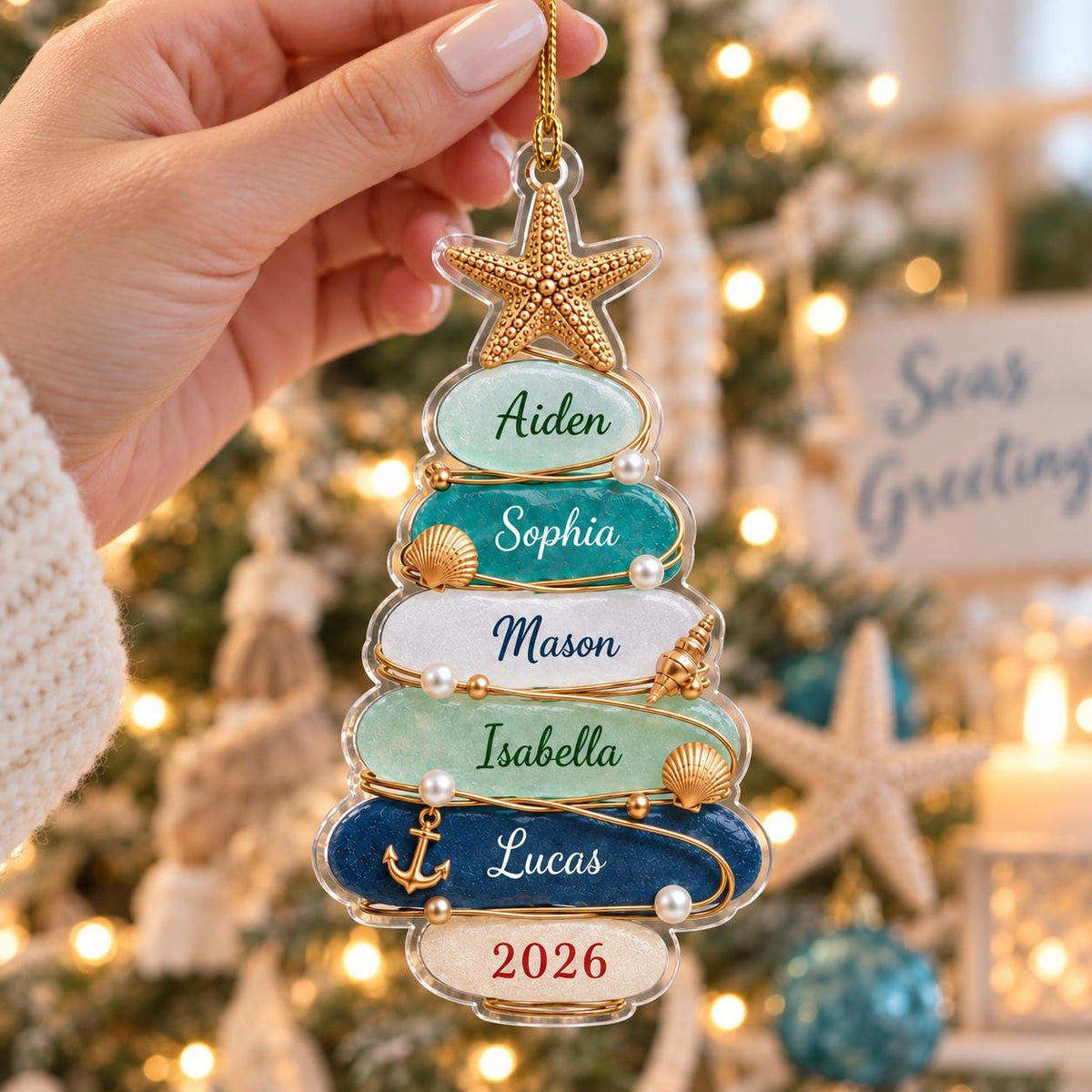 A clear acrylic Christmas tree ornament featuring five horizontal layers in shades of light green, teal, white, mint, and dark blue. The layers are personalized with the names Aiden, Sophia, Mason, Isabella, and Lucas, with 2026 at the base.