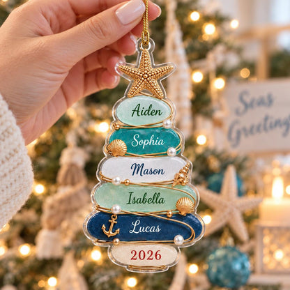 A clear acrylic Christmas tree ornament featuring five horizontal layers in shades of light green, teal, white, mint, and dark blue. The layers are personalized with the names Aiden, Sophia, Mason, Isabella, and Lucas, with 2026 at the base.