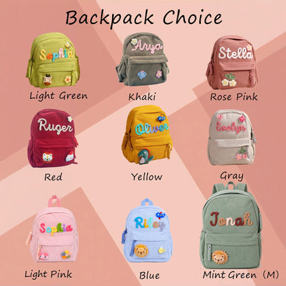 A collection of nine small backpacks in various colors including light green, khaki, rose pink, red, yellow, gray, light pink, blue, and mint green. Each backpack features a personalized name in raised letters and small decorative patches.