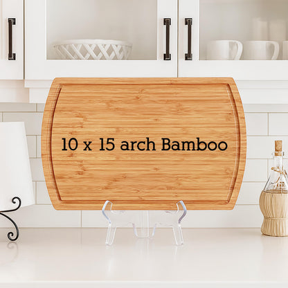 A rectangular bamboo cutting board with a curved top and bottom edges. The board measures 10 x 15 inches and has the text "10 x 15 arch Bamboo" printed on it. The board is displayed on a clear plastic stand.