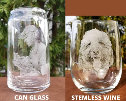 Two clear glass cups with personalized engravings. The first cup is a can-shaped glass with a man's face engraved on it. The second cup is a stemless wine glass with a dog's face engraved on it.