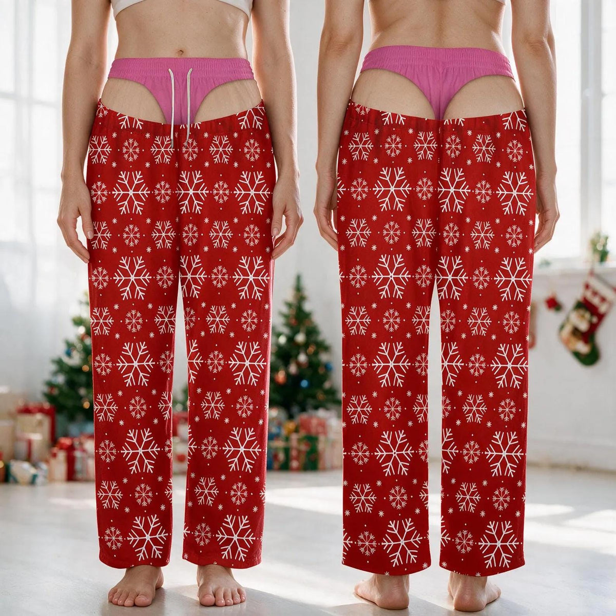 Red lounge pants featuring a repeating white snowflake pattern and a high-waisted design with an integrated pink thong detail. The pants have a straight-leg cut and are shown from both the front and back views in this composite image.