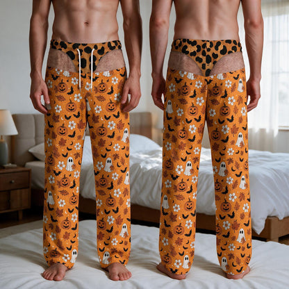 Orange lounge pants featuring a repeating Halloween pattern of jack-o'-lanterns, white ghosts, black bats, and autumn leaves. The waistband includes a leopard print section with white drawstrings, creating a trompe l'oeil effect.