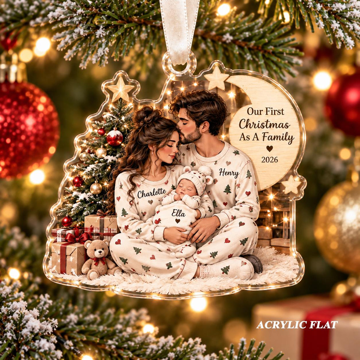May include: A clear acrylic Christmas ornament featuring a printed illustration of a family of three wearing matching pajamas with heart and tree patterns. The text reads Our First Christmas As A Family 2026, with names Charlotte, Henry, and Ella.