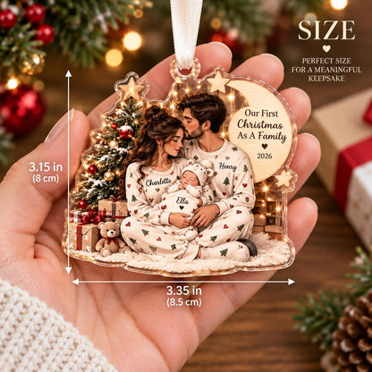 May include: A clear acrylic Christmas ornament measuring 3.15 inches by 3.35 inches, featuring a printed illustration of a family in pajamas with a baby, a Christmas tree, and the text Our First Christmas As A Family 2026 with names.