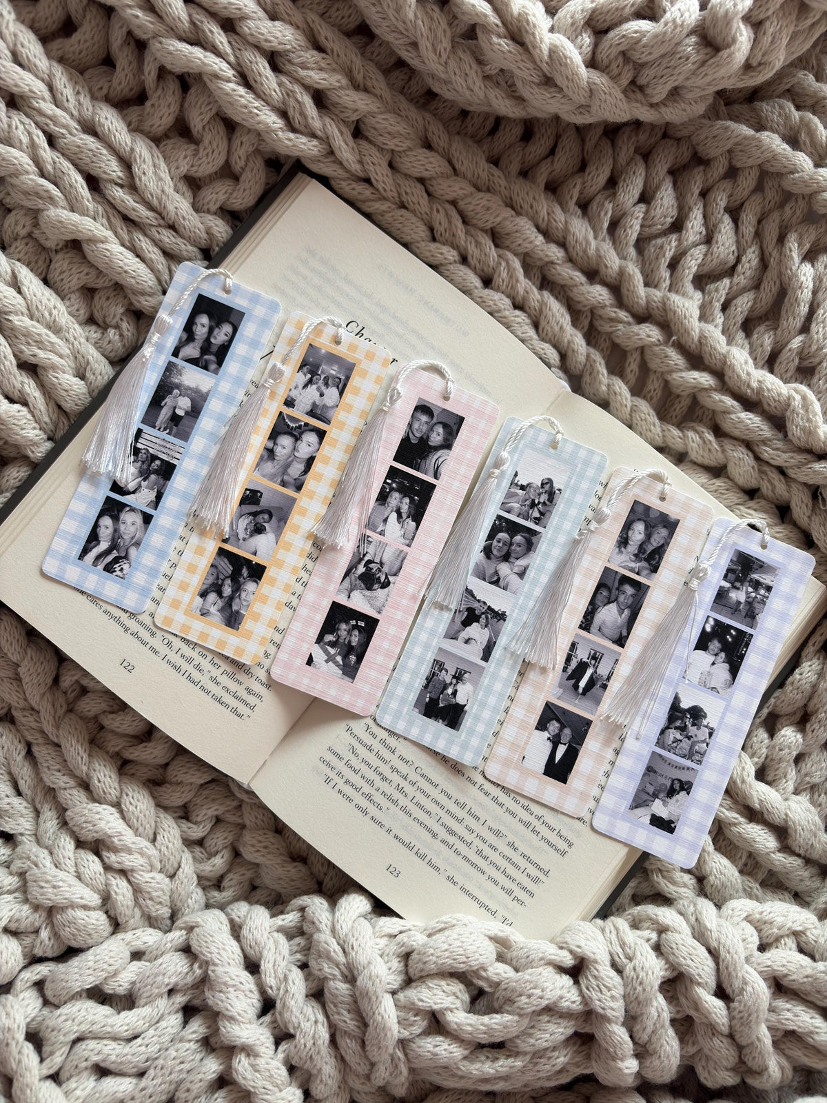 Six rectangular bookmarks with gingham patterns in blue, yellow, pink, and purple. Each bookmark features a vertical strip of black and white photo booth-style images and a white tassel attached to the top with a small white bead.