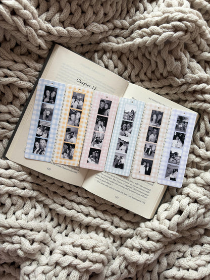 Six rectangular bookmarks with rounded corners, each featuring a vertical strip of four black and white photographs. The bookmarks have a gingham check border in blue, yellow, pink, light blue, peach, and purple, with a small hole at the top.