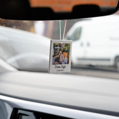 White car air freshener with a photo of a couple and the text "Drive Safe I Love You" printed on it.
