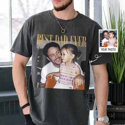 May include: Dark gray t-shirt with a photo of a man and child, and the text "BEST DAD EVER" in gold. A small photo with the text "YOUR PHOTO" is on the sleeve. The shirt is a vintage style.