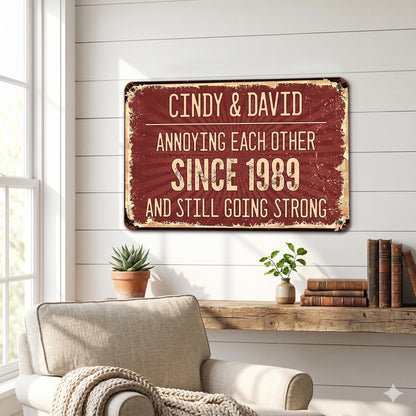 A rectangular metal sign with a distressed burgundy background and cream-colored text. The sign reads "Cindy & David Annoying Each Other Since 1989 And Still Going Strong."