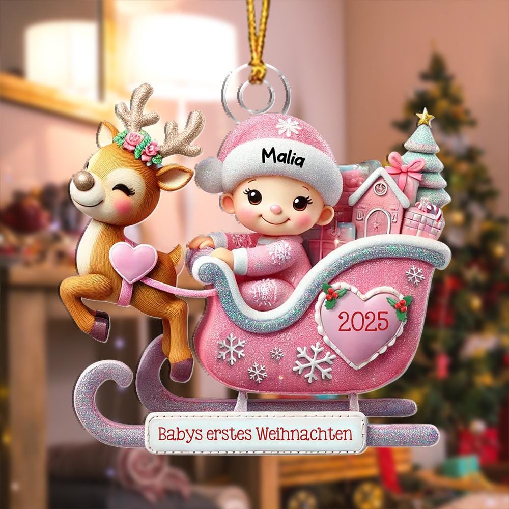 May include: A hanging Christmas ornament featuring a reindeer pulling a pink sleigh with a baby wearing a pink hat labeled Malia. The sleigh displays a heart with 2025 and a banner with the text Babys erstes Weihnachten. The design includes glittery accents and a small Christmas tree.