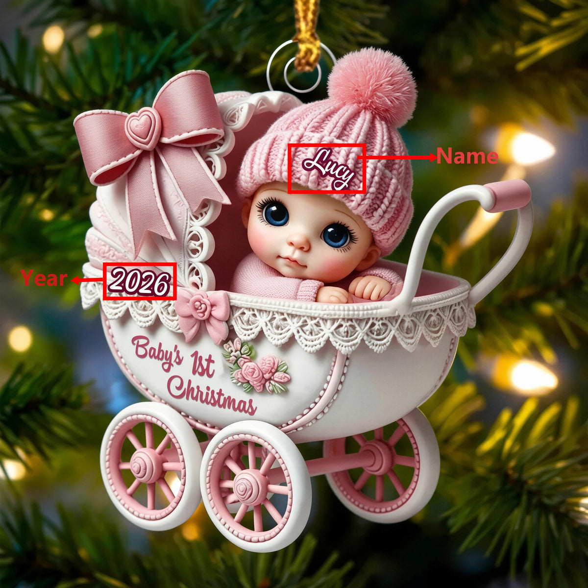May include: A decorative Christmas ornament shaped like a white and pink baby carriage with a baby wearing a pink knit hat. The carriage features a large pink bow, lace trim, and the text Baby's 1st Christmas, 2026, and a placeholder for a name.