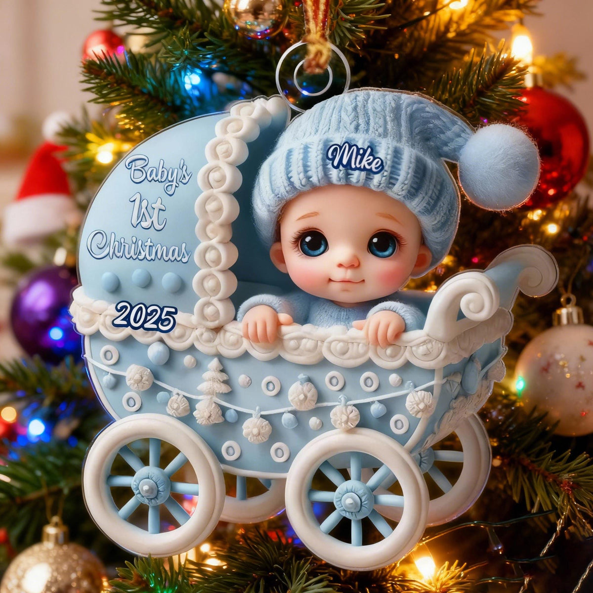 May include: A light blue baby carriage Christmas ornament featuring a baby wearing a matching blue knit hat with the name Mike printed on it. The carriage is decorated with white trim and the text Baby's 1st Christmas 2025 in blue script.