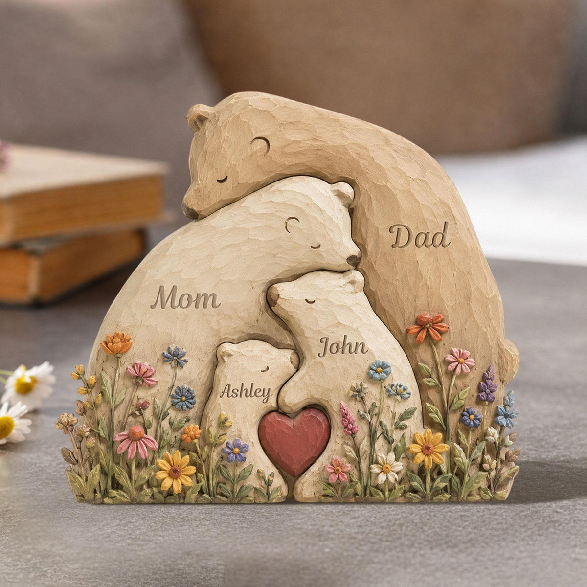 May include: A carved wooden sculpture of a bear family, with the words "Mom", "Dad", "Ashley", and "John" inscribed. The sculpture features a heart and is surrounded by colorful flowers.
