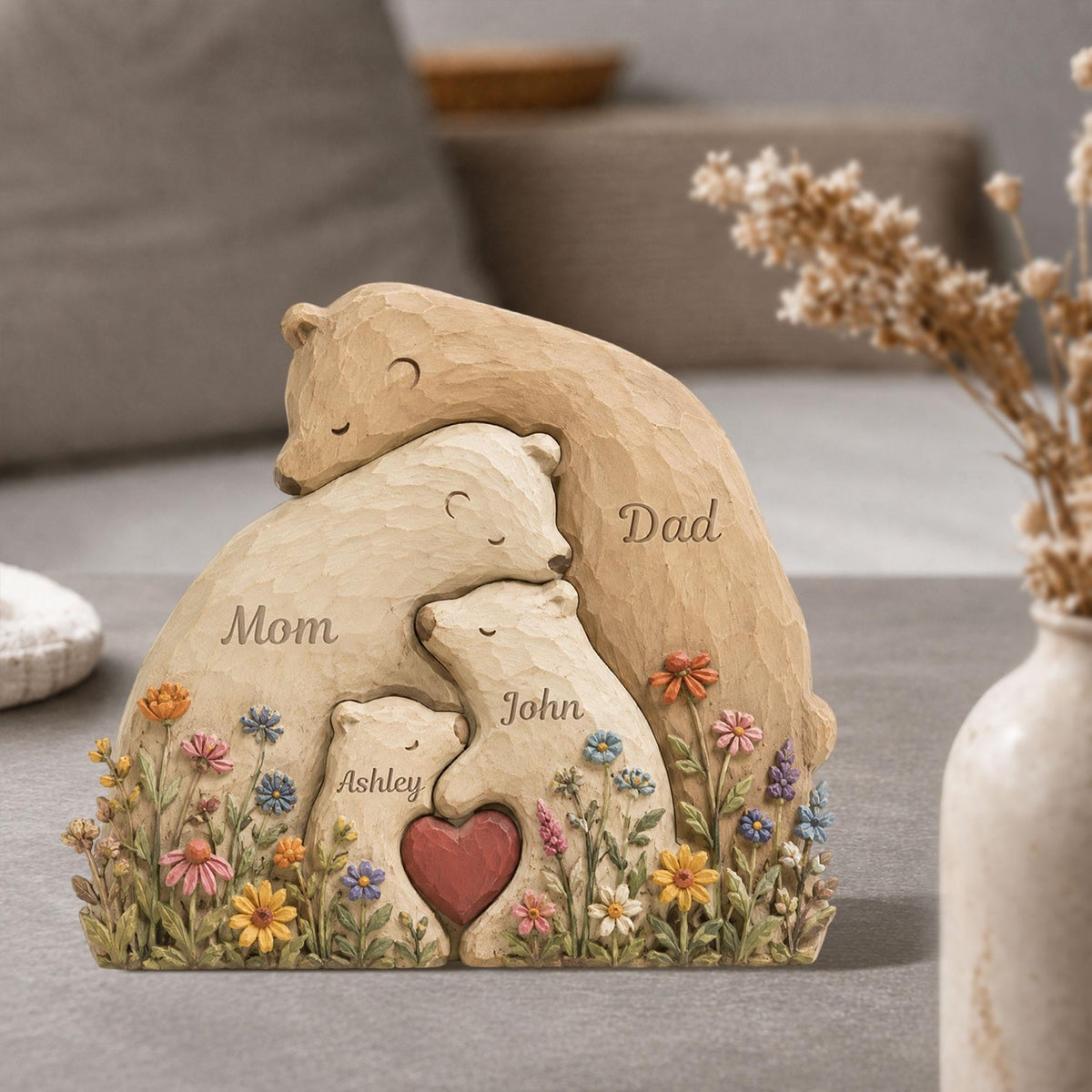 May include: A carved wooden family bear sculpture with the words "Mom", "Dad", "John", and "Ashley" inscribed. The bears are surrounded by colorful flowers and a red heart.