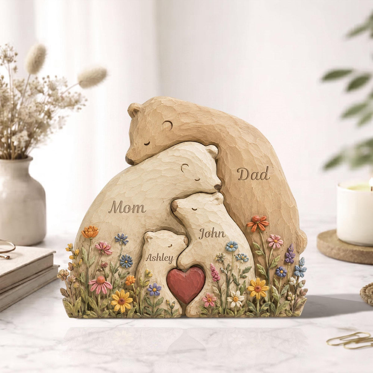 May include: A carved wooden bear family sculpture. The sculpture features a mother, father, and two children embracing, with the names "Mom", "Dad", "John", and "Ashley" carved into the bears. A red heart is in the center.