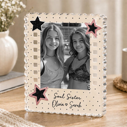 May include: A rectangular photo frame with a scalloped edge, featuring a cream-colored border with black polka dots. The frame is decorated with two black stars and two pink-rimmed black stars. Text reads: Soul Sister, Olivia heart Sarah.