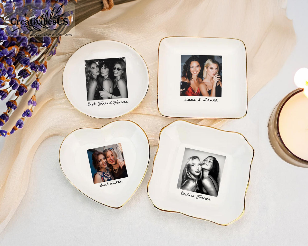 Four white ceramic trinket dishes with gold-trimmed edges, each featuring a custom printed photograph and black cursive text. The shapes include a circle, a square, a heart, and a square with scalloped edges, displaying various personal photos.