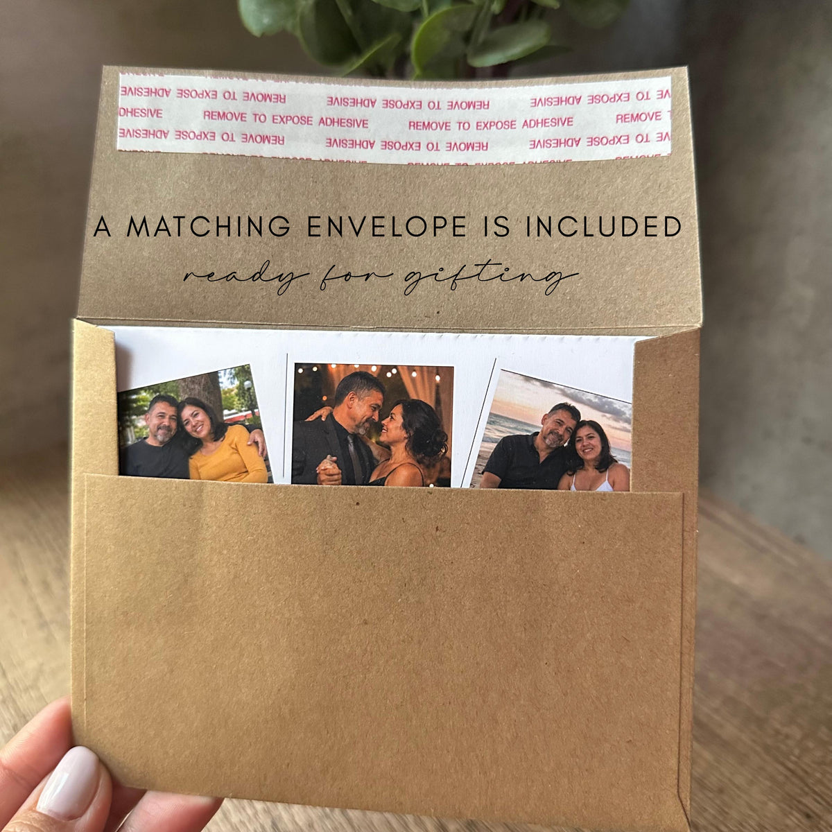 A brown kraft paper envelope containing three square photographs of a couple. The envelope flap features the text A MATCHING ENVELOPE IS INCLUDED and ready for gifting, with a white adhesive strip at the top edge for sealing.
