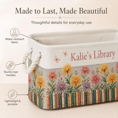 May include: A rectangular storage bin with white rope handles, featuring a printed design of colorful chrysanthemums and a row of books at the base. The text "Kalie's Library" is printed on the side, accompanied by small butterfly illustrations.