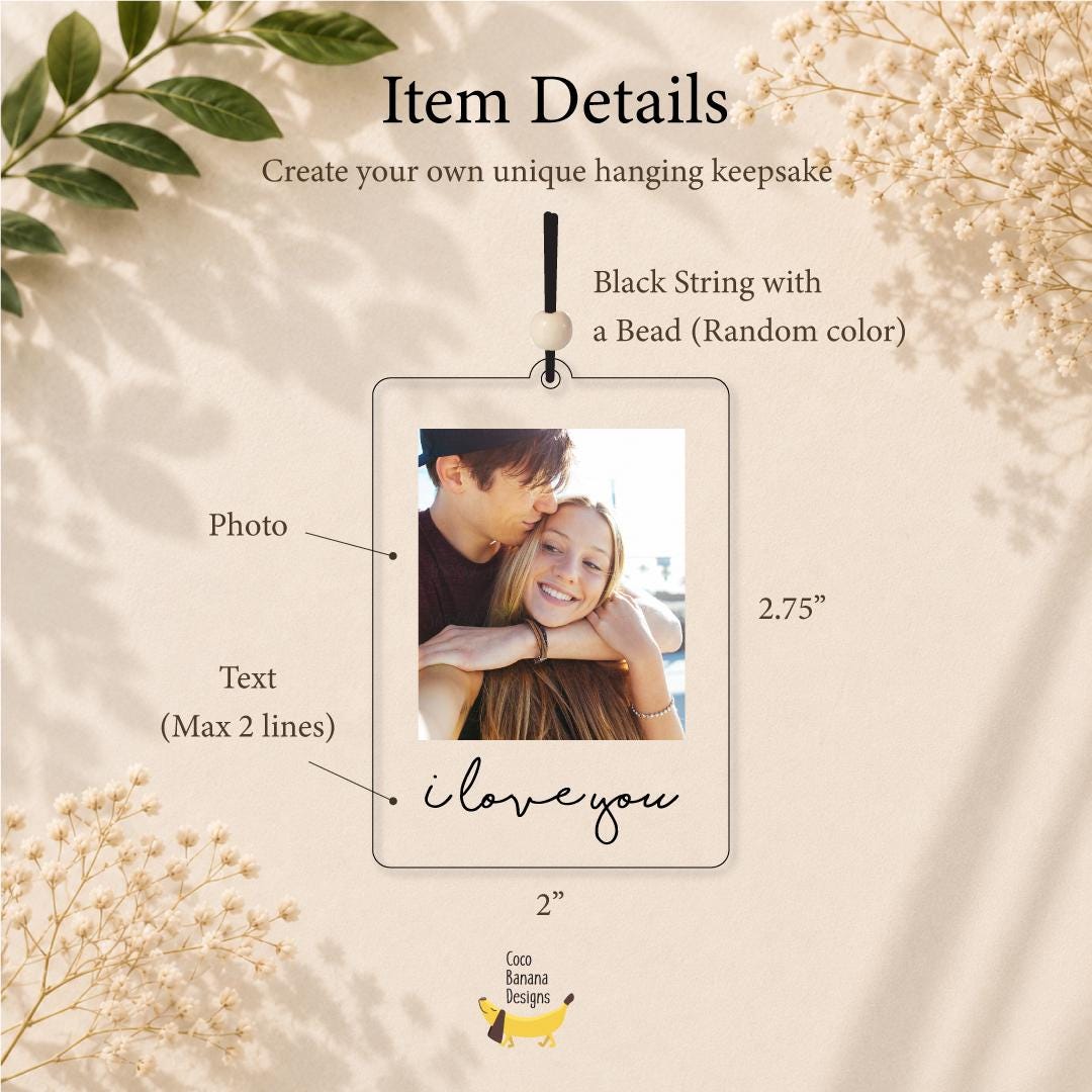 A rectangular clear acrylic hanging keepsake measuring 2 inches by 2.75 inches. It features a central photograph of two people, a black string with a bead, and the text "i love you" printed in black script at the bottom.