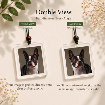 Two square acrylic ornaments featuring a portrait of a Boston Terrier. Each ornament hangs from a black cord with a dark wooden bead. The text reads Double View, Front View, Back View, and describes the printing on clear or frost acrylic.