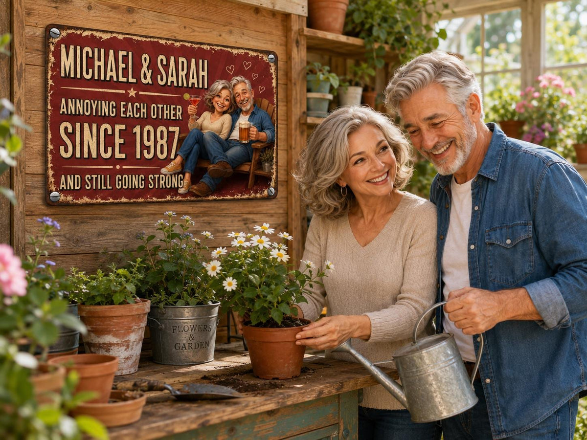 A rectangular metal sign with a distressed red border and cream background. The text reads: MICHAEL & SARAH ANNOYING EACH OTHER SINCE 1987 AND STILL GOING STRONG. It features a cartoon illustration of a couple sitting on a bench.