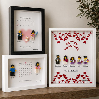 Three rectangular shadow box frames containing custom displays. Two frames feature printed calendars with minifigures and names, while the third displays the text Better Together with five minifigures and red heart illustrations.