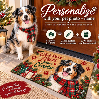 May include: A rectangular coir doormat featuring a printed illustration of an Australian Shepherd dog wearing a red and green plaid scarf. The mat includes the text Christmas Kisses from Charlie, surrounded by pine branches, red berries, and gift boxes.