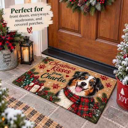 May include: A rectangular doormat featuring a tricolor Australian Shepherd wearing a red and green plaid scarf. The mat displays the text "Christmas Kisses from Charlie" with red paw prints, pine branches, and gift boxes on a tan background.