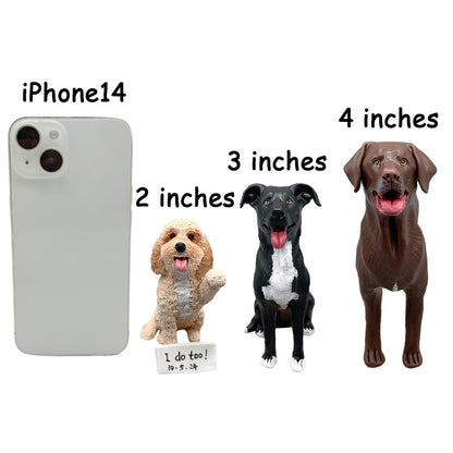 May include: Three dog figurines of varying breeds and sizes. A light brown dog is 2 inches tall, a black and white dog is 3 inches tall, and a brown dog is 4 inches tall. An iPhone 14 is to the left of the figurines. A small sign reads "I do too! 10-5-24".